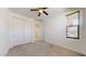 Bright bedroom with a ceiling fan, window, and spacious closet for ample storage at 3877 E Oxford Ln, Gilbert, AZ 85295