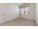 Bright bedroom with carpeted floor, white walls, and large windows with blinds at 3877 E Oxford Ln, Gilbert, AZ 85295