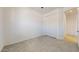 Bright bedroom featuring plush carpet, white walls, and closet with sliding doors at 3877 E Oxford Ln, Gilbert, AZ 85295