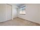 Carpeted bedroom featuring a closet with sliding doors and bright sunny window at 3877 E Oxford Ln, Gilbert, AZ 85295