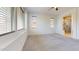 A bright bedroom showcasing wide windows and carpeted floors adjacent to a bathroom at 3877 E Oxford Ln, Gilbert, AZ 85295