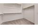 Walk in closet featuring carpet flooring and white walls with racks for organizing clothes at 3877 E Oxford Ln, Gilbert, AZ 85295