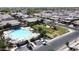 Aerial view of a sparkling community pool with sunshades, lounging area, and ample parking at 3877 E Oxford Ln, Gilbert, AZ 85295