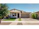Beautiful home with a well-manicured lawn, desert landscaping, and a covered front porch at 3877 E Oxford Ln, Gilbert, AZ 85295