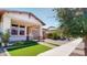 Charming home with a stone and stucco facade, manicured lawn, and inviting covered porch at 3877 E Oxford Ln, Gilbert, AZ 85295