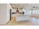 Open-concept kitchen boasts stainless appliances, tile backsplash, and large central island at 3877 E Oxford Ln, Gilbert, AZ 85295