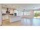 Bright, open-concept kitchen featuring a large island, modern appliances, and wood-style flooring at 3877 E Oxford Ln, Gilbert, AZ 85295