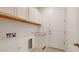 Functional laundry room with cabinets, counter space, and a utility sink at 3877 E Oxford Ln, Gilbert, AZ 85295
