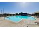 Community pool featuring lounge chairs and sunshades on a sunny day at 3877 E Oxford Ln, Gilbert, AZ 85295