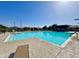 Inviting community pool showcasing crystal-clear water, comfortable lounge chairs, and sunshades at 3877 E Oxford Ln, Gilbert, AZ 85295