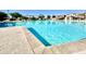 Clear blue community pool surrounded by lounge seating and sun shades for relaxing under the sun at 3877 E Oxford Ln, Gilbert, AZ 85295