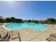 Community pool showcasing inviting lounge areas and pristine blue water for leisure and relaxation at 3877 E Oxford Ln, Gilbert, AZ 85295