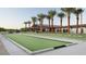 Outdoor bocce ball court at the community center with palm trees and clubhouse at 39514 N Kaden Ln, San Tan Valley, AZ 85140