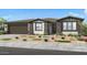 Single-story home with stone accents, desert landscaping, and a two-car garage at 39514 N Kaden Ln, San Tan Valley, AZ 85140
