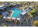 An aerial view displays the community pool, gathering spaces, and lush green landscape at 39604 N Kaden Ln, San Tan Valley, AZ 85140