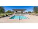A community pool with an adjacent outdoor kitchen and seating offers resort-style living at 39604 N Kaden Ln, San Tan Valley, AZ 85140