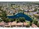 Aerial view of a community featuring lush landscaping, a large lake, and well-maintained homes with red-tiled roofs at 401 N Cholla St, Chandler, AZ 85224