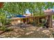 A cozy backyard patio with an outdoor kitchen, dining set, and lush landscaping perfect for entertaining at 401 N Cholla St, Chandler, AZ 85224