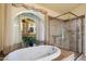 Elegant bathroom with bathtub and glass-enclosed shower, offering a spa-like retreat at 401 N Cholla St, Chandler, AZ 85224