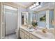 Bright bathroom features dual sinks, granite countertops, decorative mirrors, and a separate shower area at 401 N Cholla St, Chandler, AZ 85224