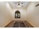 Cozy bedroom with neutral walls, ceiling fan, plush carpet and arched window with decorative shutters at 401 N Cholla St, Chandler, AZ 85224