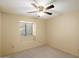 Cozy bedroom featuring neutral walls, carpet, a window with blinds and a ceiling fan at 401 N Cholla St, Chandler, AZ 85224