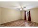 Cozy bedroom with wood floors, ceiling fan and window with curtains, offering a comfortable space at 401 N Cholla St, Chandler, AZ 85224