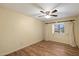 Bright bedroom with wood floors, ceiling fan, and a window with sheer curtains, creating a serene atmosphere at 401 N Cholla St, Chandler, AZ 85224