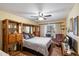 Cozy bedroom with hardwood floors, a ceiling fan, and a window seat overlooking the backyard at 401 N Cholla St, Chandler, AZ 85224
