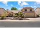 Charming two-story home featuring a well-manicured front yard and a spacious two-car garage at 401 N Cholla St, Chandler, AZ 85224