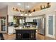 Bright kitchen with a granite countertop island and stainless steel refrigerator at 401 N Cholla St, Chandler, AZ 85224