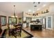 Open concept kitchen and dining area with stainless steel appliances and custom lighting fixtures at 401 N Cholla St, Chandler, AZ 85224