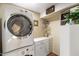 Convenient laundry room with washer, dryer, and custom cabinets for organized storage solutions at 401 N Cholla St, Chandler, AZ 85224