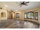 Open living room featuring recessed lighting, plank flooring, decorative shutters and multiple ceiling fans at 401 N Cholla St, Chandler, AZ 85224