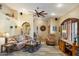 Bright living room featuring a ceiling fan, and an arched entryway at 401 N Cholla St, Chandler, AZ 85224