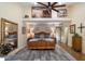 Spacious main bedroom with wood floors, and a large desert landscape painting at 401 N Cholla St, Chandler, AZ 85224