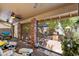 Covered patio with brick pillars, ceiling fan, and access to the outdoor seating and landscaping at 401 N Cholla St, Chandler, AZ 85224