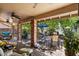 Covered patio with brick pillars, ceiling fan, and access to the outdoor seating and landscaping at 401 N Cholla St, Chandler, AZ 85224
