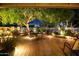 Charming brick patio with outdoor dining, surrounded by lush greenery and subtle landscape lighting at 401 N Cholla St, Chandler, AZ 85224