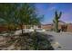 Charming desert backyard featuring a covered patio, mature trees, and a towering saguaro cactus at 4045 E Desert Marigold Dr, Cave Creek, AZ 85331