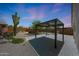 The private backyard features desert landscaping, cacti and a covered patio at 4045 E Desert Marigold Dr, Cave Creek, AZ 85331