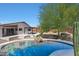 Private backyard with a swimming pool, desert landscaping, and covered patio area at 4045 E Desert Marigold Dr, Cave Creek, AZ 85331