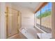 A view of a bathtub with a shower, a window and a tile floor at 4045 E Desert Marigold Dr, Cave Creek, AZ 85331