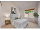 Cozy bedroom with a neutral color palette, decorative artwork, a window, and soft natural light at 4045 E Desert Marigold Dr, Cave Creek, AZ 85331