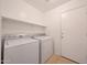 Bright laundry room featuring a washer, dryer, and storage shelf at 4045 E Desert Marigold Dr, Cave Creek, AZ 85331