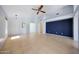 Open living room with tile floors, white walls, and a modern ceiling fan at 4045 E Desert Marigold Dr, Cave Creek, AZ 85331