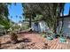 A brick patio offers a relaxing outdoor space, complemented by desert landscaping and mature trees at 4142 N 35Th St, Phoenix, AZ 85018