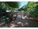 Fenced backyard area with a charming play area and mature landscaping with palms and trees at 4142 N 35Th St, Phoenix, AZ 85018