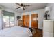 Bedroom with original hardwood floors, retro ceiling fan, and large closets for ample storage space at 4142 N 35Th St, Phoenix, AZ 85018