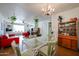 A dining room is styled with a vintage chandelier and dining set adjacent to a large comfortable living area at 4142 N 35Th St, Phoenix, AZ 85018